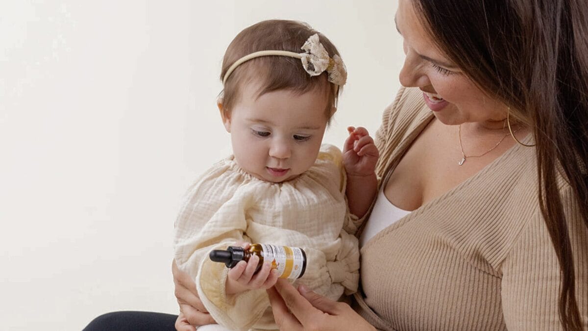 mom and baby holding a vitamin d supplement from serawise brand